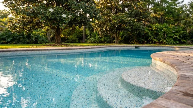 Crystal-clear water in a freshly resurfaced inground swimming pool in a Louisiana backyard